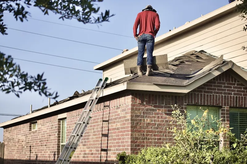 Professional roofer working on a residential roof in Indian Meadows